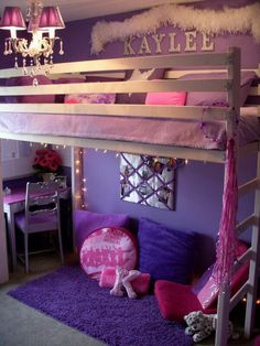 a loft bed with purple and pink decor