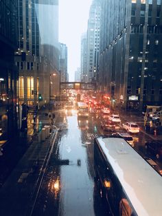 a city street filled with lots of traffic next to tall buildings in the night time