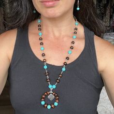 This beaded necklace was made by linking the beads together by hand with 20 gauge wire. The beads are lightweight, and the turquoise color really pops amongst the dark brown wooden beads. Matching earrings sold separately :) Brown Beaded Southwestern Jewelry, Southwestern Brown Beaded Jewelry, Southwestern Style Brown Beaded Jewelry, Artisan Brown Turquoise Necklace For Jewelry Making, Artisan Beaded Brown Turquoise Necklace, Artisan Turquoise Necklace With Wooden Beads, Artisan Brown Beaded Turquoise Necklace, Artisan Brown Turquoise Necklace With Gemstone Beads, Rustic Beaded Turquoise Necklace