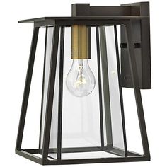 an outdoor wall light with a clear glass shade