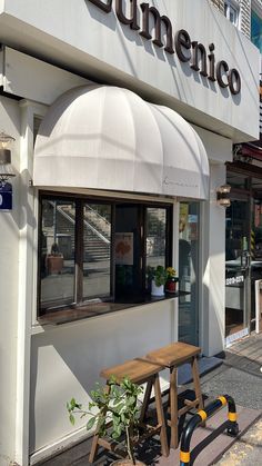 an outside view of a restaurant with a wooden bench