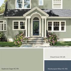 a gray house with white trim and blue shutters on the front door is featured in this color scheme