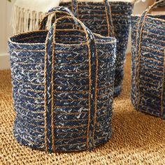 three blue baskets sitting on top of a rug