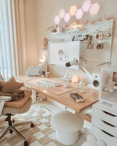 a room with a desk, chair and computer on top of the desk is decorated in pastel colors