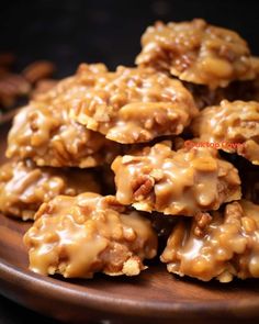 some cookies are stacked on top of each other with caramel glaze and pecans