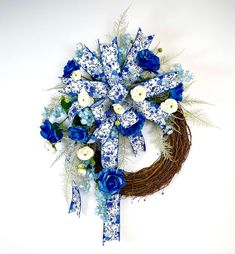 a wreath with blue and white flowers on it