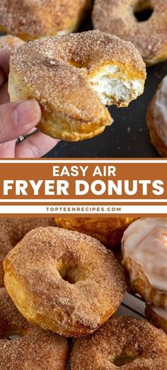 a person holding up a donut with icing and cinnamon on it, in front of a pile of other doughnuts