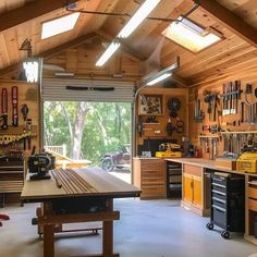 a garage with lots of tools and work benches in it's center area,