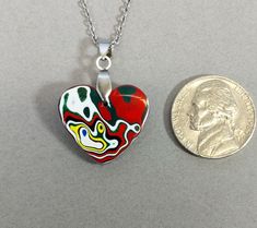 This fordite heart necklace is a great example of modern fordite. This piece is reversible with different colors on each side. The heart comes with a stainless steel bail and the pictured 20 inch stainless steel chain making it worry free jewelry. This fordite is from Ohio and occurred as a byproduct of painting parts for freightliners. This heart measures about 20 x 21 mm. Fordite is recycled automotive paint sourced from automotive factories as well as manufacturers who paint parts for new vehicles. It forms in thin layers as car parts are painted on the racks that hold them in place. After hundreds of trips through the booth where the paint is sprayed and then baked the excess buildup is scraped off the racks. We buy this waste paint in rough chunks and recycle it into beautiful jewelry Fordite Jewelry, Chain Heart, Chain Making, Automotive Paint, Vehicle Paint, Agate Pendant, Valentine Heart, Steel Chain, Stainless Steel Chain