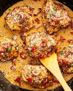 meatballs covered in sauce and garnished with parsley on a skillet