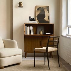 a living room with a chair and book shelf