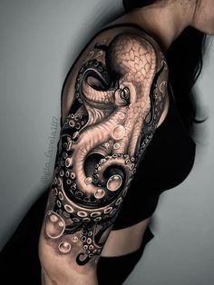 an octopus tattoo on the arm with bubbles and water in its tentacles, it is black and white