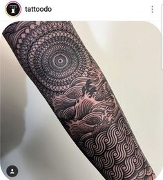 a person with a black and white tattoo on their arm that has an intricate design