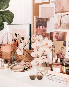 a table topped with lots of different types of items next to a potted plant