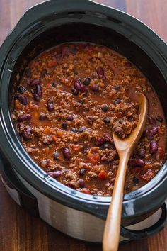 a slow cooker filled with chili and beans