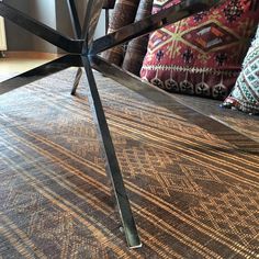 a metal table sitting on top of a carpet covered floor