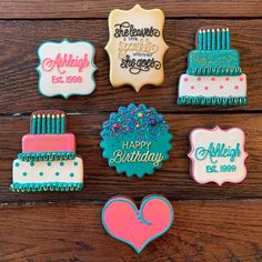 decorated cookies are arranged on a wooden table with the words happy birthday written in different languages