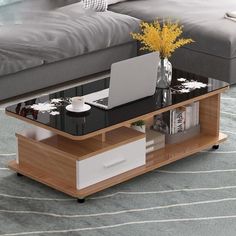 a coffee table with a laptop on it