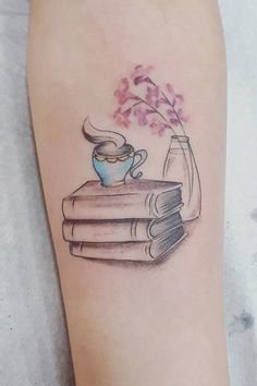 a tattoo on the leg of a woman with books and a tea cup