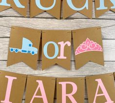 brown paper banner with pink and blue princess crown on it that says rock or lara