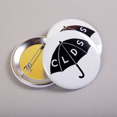 two badges with the words clss and an umbrella