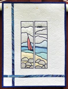 a quilted wall hanging on the side of a wooden door with two sailboats in it