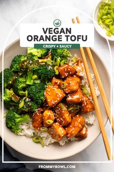 a white plate topped with chicken and broccoli next to chopsticks