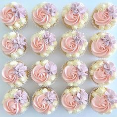 cupcakes with pink and white frosting are arranged in the shape of roses