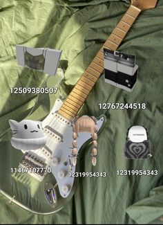 an electric guitar is laying on a green sheet with other items surrounding it, including the neck and bridge