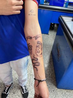 a person with a tattoo on their arm holding onto another person's arm and leg