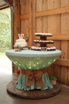 a table that has some cakes on top of it in front of a wooden wall