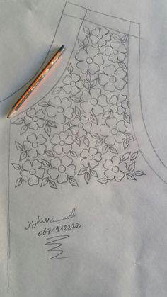 a drawing of a dress with flowers on it and a pencil next to the design