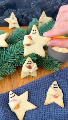 someone is decorating cookies with icing and decorations