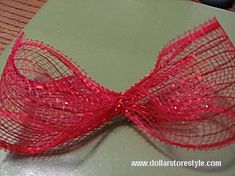 a close up of a red bow on a table