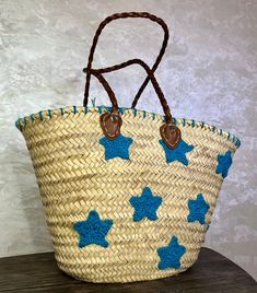 a straw bag with blue stars on it