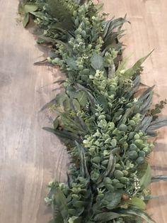 a bunch of green plants sitting on top of a wooden table