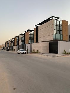 an empty street with cars parked on the side