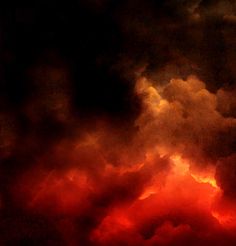 an airplane flying in the sky with red and black clouds