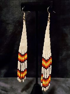 Beautifully crafted Native American earrings that show the simplicity and elegance of Native colors. Made with white pearl bugle beads and beautifully colored seed beads, these will definitely stand out in any way you decide to wear them. White Long Drop Earrings With Colorful Beads, White Beaded Long Drop Earrings, Traditional White Beaded Earrings With Ear Wire, White Long Drop Earrings With Dangling Beads, Native American Beadwork Earrings, Mountain Earrings, Beadwork Earrings, Native American Earrings, Native Beadwork