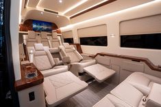 the inside of a private jet with white leather seats