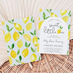 the lemon themed wedding stationery is laid out on top of a wicker basket