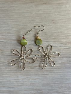 Flower Wire Earrings with green and brown beads. Boho, earthy, abstract dangle earrings. Handmade to order.  Message for inquiries, can change metal type/colors or bead colors upon request prior to order. Items are handmade and may vary slightly per each piece. Thank you for supporting my small business! Bohemian Brown Dangle Flower Earrings, Unique Green Dangle Flower Earrings, Green Bohemian Flower Earrings For Gift, Brown Bohemian Drop Flower Earrings, Bohemian Brown Flower Earrings, Green Beaded Pierced Earrings, Brown Dangle Flower Earrings, Bohemian Flower-shaped Pierced Earrings, Handmade Green Flower Drop Earrings