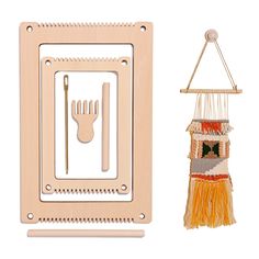 a wooden frame with a fork and spoon hanging from it's side next to a weaving kit