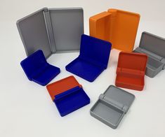 six different colored plastic boxes with dividers