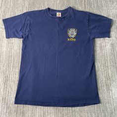 Vintage 2000s NYPD Police Badge Cops Y2K Aesthetic Streetwear Stitched Embroidered Navy Graphic T Shirt Large Mens Condition:  Excellent Used Condition  = No Flaws Measurements: Please see photos above for all measurements IF YOU BUY TWO OR MORE ITEMS USE THE CODE BUNDLE @ CHECK TO SAVE 20% WE SHIP WITHIN 24 HOURS AFTER PURCHASE! Please be aware that we do not offer free returns!! The Buyer is responsible for the cost of the return label.  Follow us on TikTok & Instagram @findsnostalgic and tag 90s Streetwear Tops With Embroidered Logo, 90s Embroidered Logo Tops For Streetwear, 90s Style Tops With Embroidered Logo For Streetwear, Blue Embroidered T-shirt For Streetwear, 90s Embroidered Top For Streetwear, Vintage Badge, 2000s Clothes, Aesthetic Streetwear, Police Badge