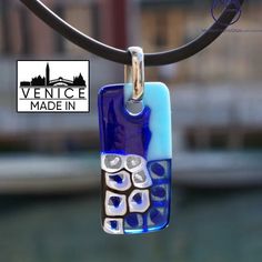 This pendant was created by our artist in the island of Murano using the fused technique with Murrina blue. The combination of style and design is the perfect feature of this glass art work. Delivery made with gift box and warranty card. - All our items come with a Made in Murano Warranty Certificate. - Dimensions: Height 1 cm (inches 0,39) Length 4 cm (inches 1,57) Weight 20 grams Modern Blue Pendant Jewelry, Modern Blue Necklaces As A Gift, Modern Blue Rectangular Jewelry, Blue Square Pendant Jewelry For Gift, Artisan Blue Necklace With Artistic Design, Blue Pendant Necklace With Artistic Design, Blue Square Pendant Necklace For Gift, Modern Blue Jewelry With Unique Variations, Blue Artistic Pendant Necklace