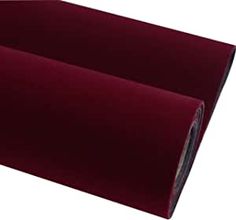 a roll of burgundy colored paper on a white background