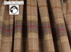 a brown and red plaid curtain with a white label on it that says 100 % wool home delivery