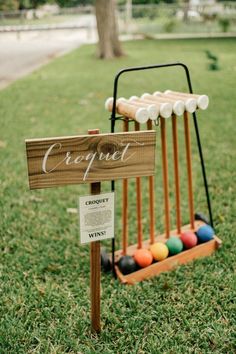 a wooden croquet stand with balls in it