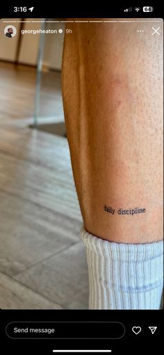 a person's leg with the words daily discipline tattooed on their left calfs